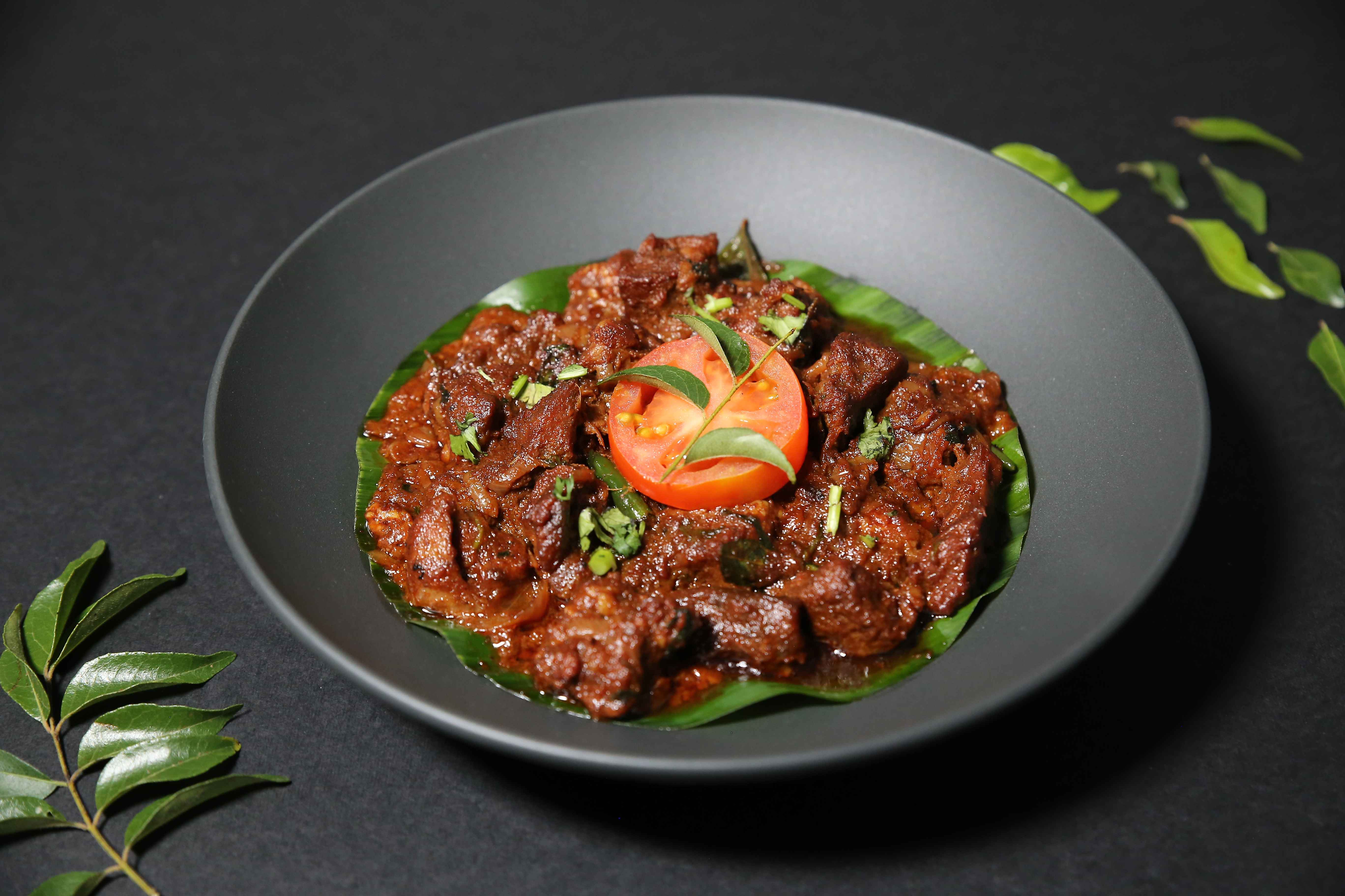A traditional Kerala-style dry roast with tender beef slow-cooked and stir-fried with coconut slices, curry leaves, and spices until rich and caramelised. A must have with Parotta